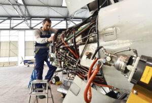 Man working on a plane 